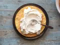 Una fetta di pan di spagna attende la sua deliziosa crema allo yogurt, spalmata con un cucchiaino.