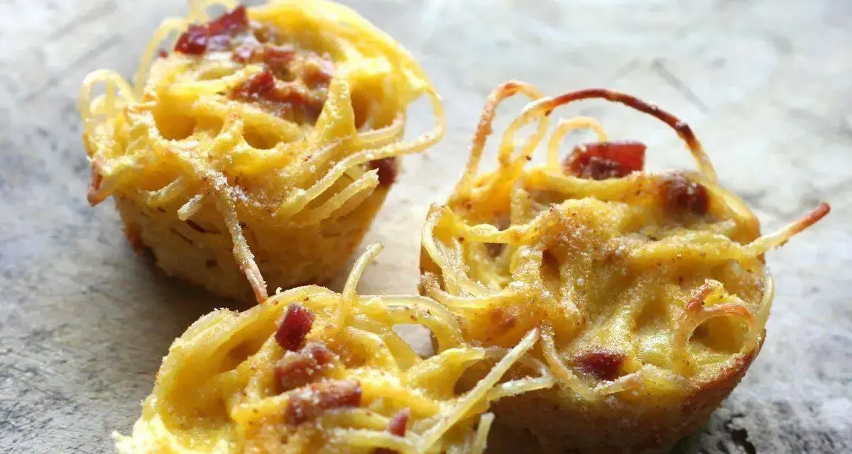 Tre tortini di pasta fritta senza glutine, dorati e croccanti, con pezzetti di pancetta.