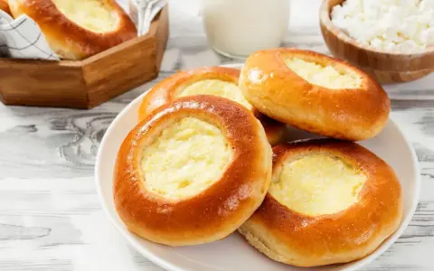 Dolci **drożdżówki z serem**, dorate e invitanti, pronte per essere gustate.