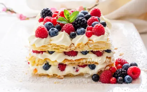 Delizioso millefoglie con frutta fresca, panna montata e un tocco di zucchero a velo. Un tripudio di lamponi, mirtilli e more.