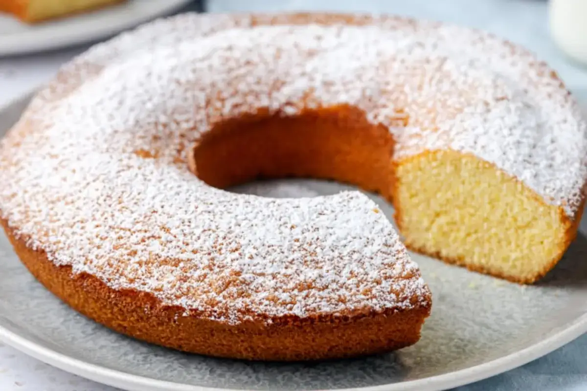 Ciambella soffice e dorata, cosparsa di zucchero a velo, perfetta per chi cerca una ciambella per celiaci gustosa e senza glutine.